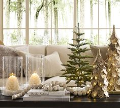 christmas trees and candles on a coffee table