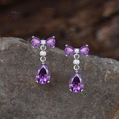 Product Detail Material: 925 Sterling Silver, 10k/14k/18k Solid Rose/White/Yellow Gold, Platinum Quantity: 2pcs (a pair) earrings Center Stone: 6x8mm Pear Cut Natural Amethyst Side Stones: 4x4mm Trillion Cut Natural Amethyst and Round Cut Lab Opal/Moissanites Custom Service 1, Gemstones can be replaced with others. 2, All metal can be customized. 3, The earrings can be customized according to the design you want. Please contact us if you need any personalized custom earrings. We will try our best to meet your needs. Only you can't think of it, we can't do it without us. Shipping It's made-to-order jewelry, it will take 2-4 weeks to make it. Once the pendant/necklace is finished, it will be sent by USPS, FedEx or DHL. Return & Refund There is a 30-day return guarantee. But as it's handmade Earrings Art Deco, Handmade Pendant Necklace, Stone Dangle Earrings, Earrings Art, Art Deco Earrings, Custom Earrings, Etsy Earrings Dangle, Gold Platinum, Pear Cut