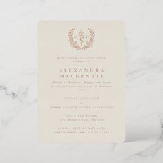 an elegant wedding card with a monogrammed crest on the front and bottom in gold foil