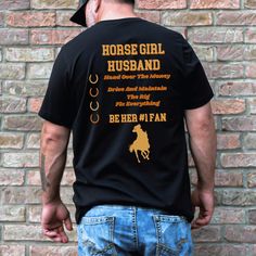 Horse lovers, rejoice! Introducing our Horse Girl Husband t-shirt, designed exclusively for the supportive partners of equestrian enthusiasts. This playful tee showcases the words "Horse Girl Husband" in a stylish font on the back, allowing you to proudly display your role. In addition, the shirt features the phrase "Hand Over the Money, Drive and Maintain the Rig, Fix Everything, and Be Her #1 Fan." This fun and light-hearted design perfectly captures your commitment and love for your wife's pa Dad Shirts, Girl Dad, Stylish Fonts, Long Cut, Scoop Neck Tank Top, Love And Support, Clothes Horse, Horse Girl, Horse Lover