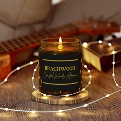 a candle sitting on top of a table next to a guitar