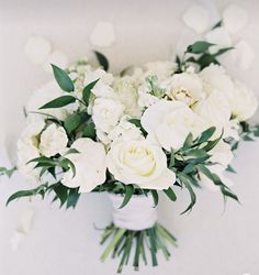 a bouquet of white flowers sitting on top of a table