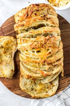 a wooden plate topped with cheesy bread