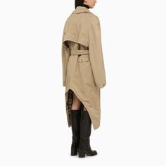 Beige cotton canvas trench coat from Balenciaga featuring an asymmetrical hem, a belted waist, a button fastening, a check lining, an oversized long sleeve and two front pockets.Model wears size 36 FR Model measurements: Height: 179 cm Chest: 82 cm Waist: 65 cm Hips: 90 cmFabric I: 100% Cotton / Lining: 100% Wool / Sleeves Lining: 100% Cupro Cristobal Balenciaga Coat, Cotton Trench Coat, Trench Jacket, Oversized Long Sleeve, Leather Cap, Trench Coats Women, Women's Wardrobe, Asymmetrical Hem, Denim Pant