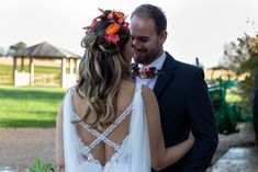 the bride and groom are standing close together