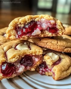 two cookies are stacked on top of each other with cherries and white chocolate in the middle