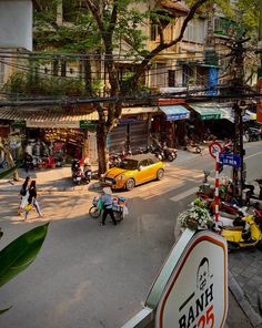 a busy city street filled with lots of traffic and people walking around the area next to tall buildings