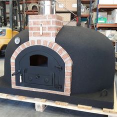 an outdoor brick pizza oven in a warehouse