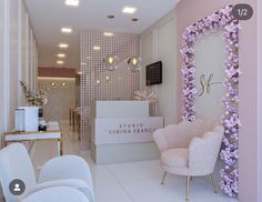 the interior of a salon with white chairs and pink flowers on the wall behind it