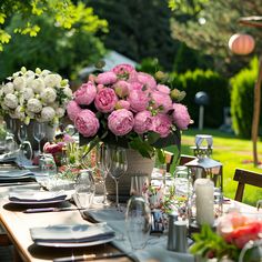 a table set with pink and white flowers