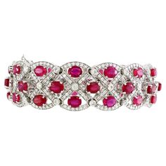 A bracelet of extraordinary allure, this piece exudes elegance and opulence with its 22.5-carat ruby ensemble. The bracelet features 45 oval-shaped rubies, each radiating a rich and fiery charm. Securely nestled in a delicate yet sturdy 4-prong setting, the rubies, totaling 22.47 carats, showcase their natural beauty. Enhancing the ensemble, 405 dazzling white diamonds, totaling 3.71 carats, dance alongside the rubies. Skillfully placed in a combination of shared prong and bezel settings, the di Diamond Pendants Designs, Ruby Bracelet, Modern Bracelets, White Gold Bracelet, Large Gift, Fine Jewels, Ruby Diamond, Pendant Design, Yellow Sapphire