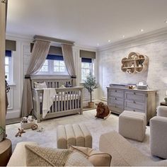 a baby's room is decorated in white and gray colors with neutral furniture, including a crib