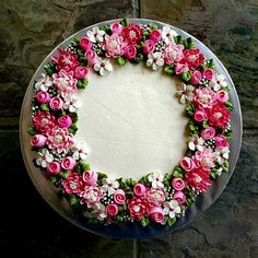 a cake decorated with pink and white flowers