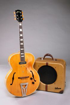 an old guitar and amp are sitting next to each other