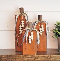 two wooden pumpkins are sitting on a shelf