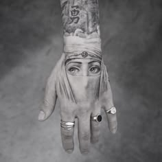 a person's hand with tattoos on it