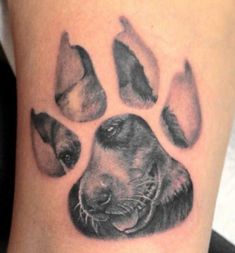 a black and white photo of a dog's paw with four different dogs on it