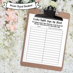 a clipboard with a list on it next to flowers