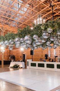 an indoor dance floor with ornaments hanging from it's ceiling and lights on the ceiling