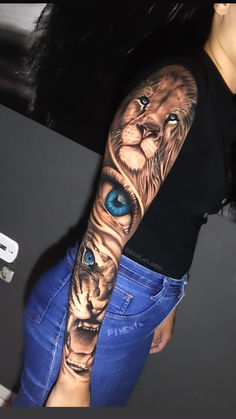 a woman's arm with a lion and blue eye tattoo on her left arm