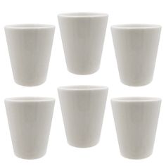 six white cups sitting next to each other