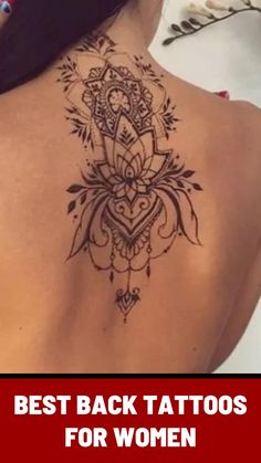 the back of a woman's shoulder with an intricate tattoo design on her left side