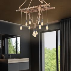 a chandelier hanging from the ceiling in a bathroom next to a large window