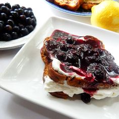 lemon blueberry stuffed french toast on a white plate