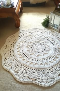 a white crocheted doily sitting on the floor next to a coffee table