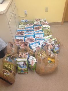 many bags of diapers are lined up on the floor