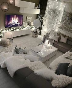 a living room filled with lots of furniture and christmas lights on the wall behind it