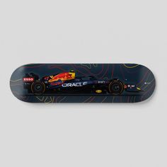 a skateboard with the image of a red bull racing car on it's side