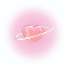 a pink heart shaped object sitting on top of a white ring in front of a pink background