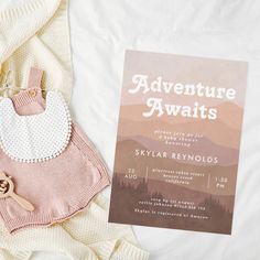 a baby bib and card laying on top of a blanket