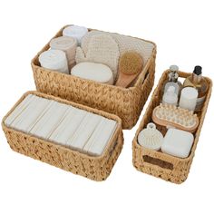 two wicker baskets with soaps, lotion and other items in them on a white background