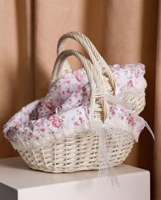 a wicker basket sitting on top of a white box