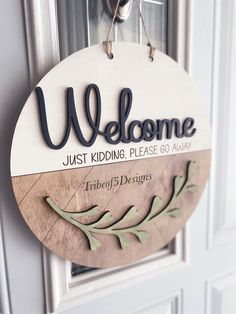 a welcome sign hanging on the front door