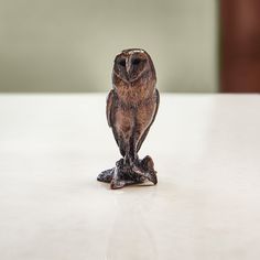 an owl figurine sitting on top of a table