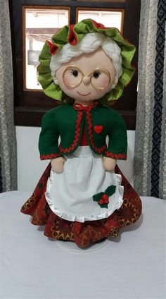 an old fashioned doll sitting on top of a table