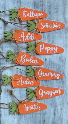 carrots with name tags tied to them sitting on a table