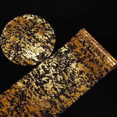 gold and black paint splattered onto an object