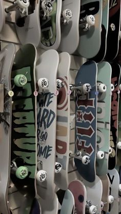 many skateboards are lined up on the wall and ready to be used for display