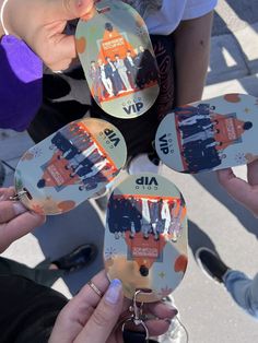 four people holding up their badges in the air