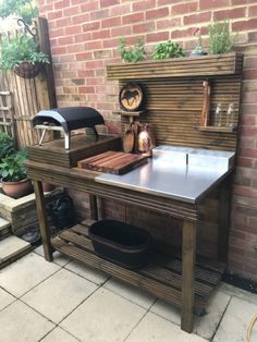 an outdoor grill made out of wood and metal