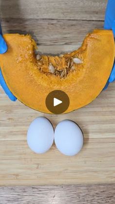 two eggs are sitting on a cutting board next to a half - eaten banana and blue gloves