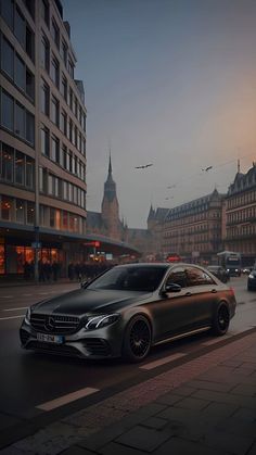 a car is driving down the street in front of some buildings