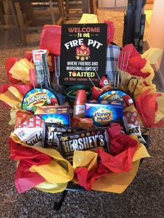 a basket filled with food and snacks on top of a table next to a sign