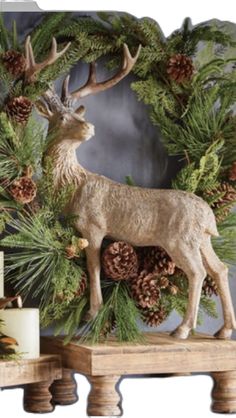 a deer figurine sitting on top of a wooden table next to pine cones