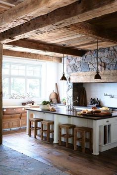 a kitchen with an island and wooden beams