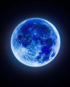 the blue moon is shining brightly in the dark night sky with stars on its side